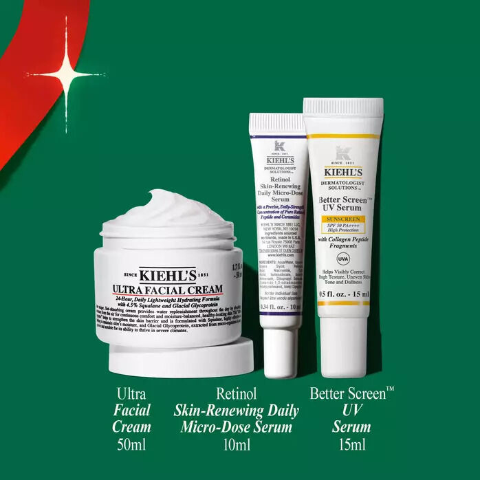 Three Kiehl's skincare products on a green holiday-themed background: Ultra Facial Cream (50ml), Retinol Skin-Renewing Daily Micro-Dose Serum (10ml), and Better Screen UV Serum (15ml).​