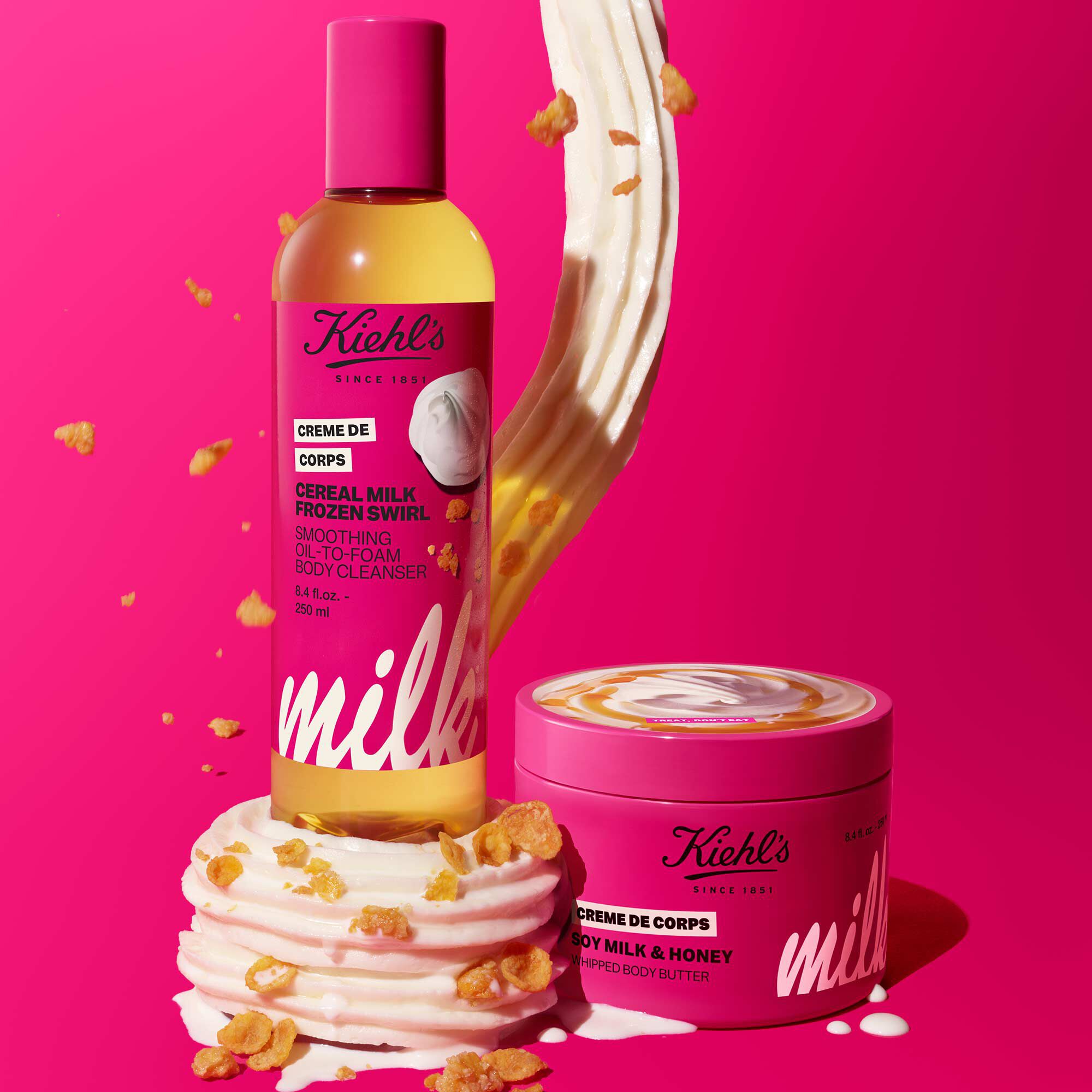 Kiehl’s limited-edition pink skincare duo featuring Rare Earth Deep Pore Cleansing Mask and Milk Bar Creme de Corps Whipped Body Butter, styled with whipped cream and a golden cream splash.​