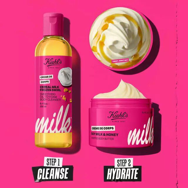 Kiehl's "Milk" collection set on a pink background, featuring Step 1: Cereal Milk Frozen Swirl Oil-to-Foam Body Cleanser and Step 2: Soy Milk & Honey Whipped Body Butter.​