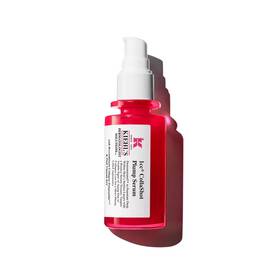 A vibrant red bottle of Kiehl's Hydro-Plumping Serum with a white pump dispenser. The product is centered against a plain white background, highlighting its bold packaging and label.