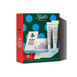 Kiehl's holiday skincare gift set featuring a moisturizer jar, two tubes, and a cartoned product inside festive green, red, and blue polka-dot packaging.​