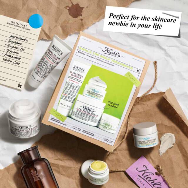 Kiehl's Top Shelf Treatments Gift Set on top of paper with elements scattered around​