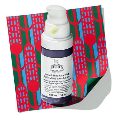 Kiehl's Retinol Skin- Renewing Daily Micro-Dose Serum bottle with a dollop of serum on the pump, resting on a patterned holiday background.​  ​