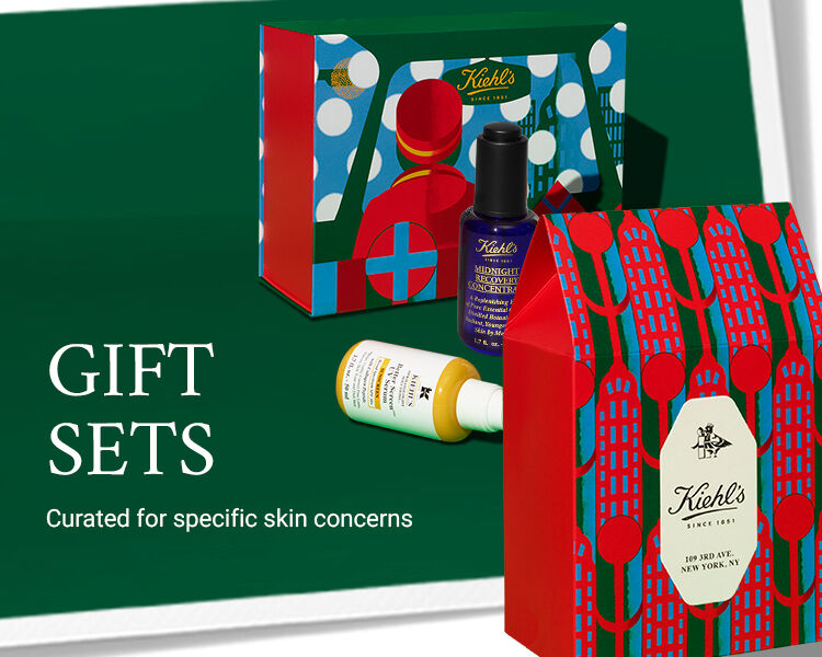 Kiehl's promotional banner featuring holiday gift sets and skincare products against a green background.​